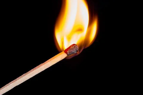 Burning match isolated on black background Stock Photos