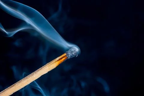 Burning match isolated on black background Stock Photos