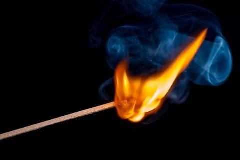 Burning match isolated on black background Stock Photos