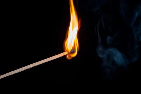 Burning match isolated on black background Stock Photos