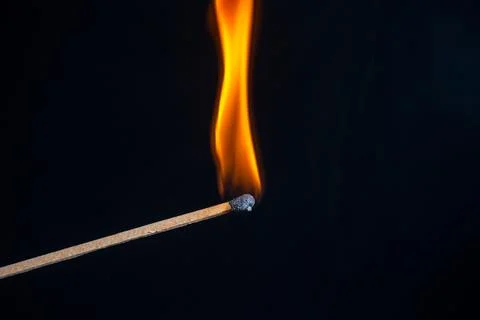 Burning match isolated on black background Stock Photos