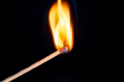 Burning match isolated on black background Stock Photos