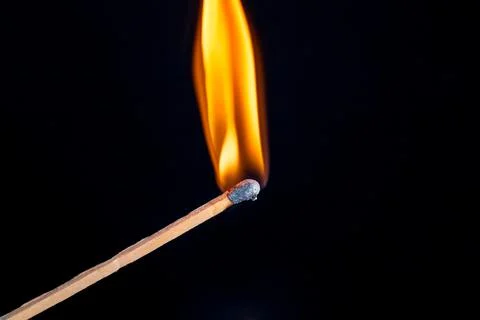 Burning match isolated on black background Stock Photos