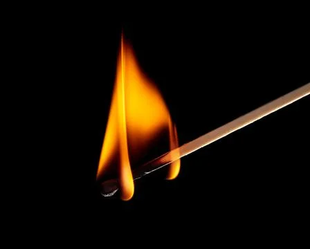 Burning match isolated on black background. Close-up. Stock Photos