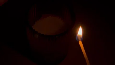A burning match lights a candle Stock Footage 304611445