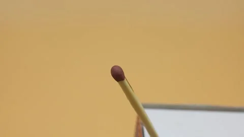 Burning match stick on yellow background Stock Footage 169943165