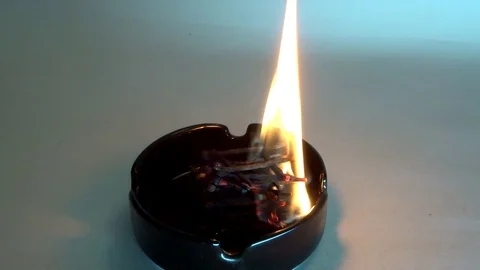 Burning matches in an ashtray Stock Footage 94952845