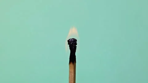 Burning matchstick on blue background Stock Footage 304419402