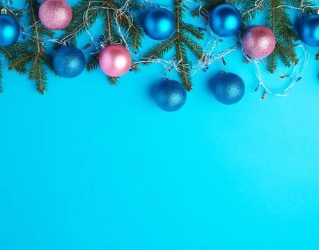 Burning multi-colored light bulbs on a garland with a white cable and green.. Stock Photos