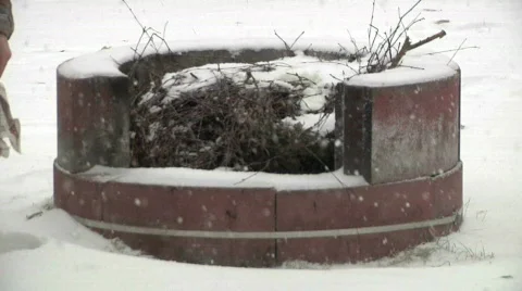 Burning newspaper lights explosive fire in snowstorm closeup Stock Footage 573729