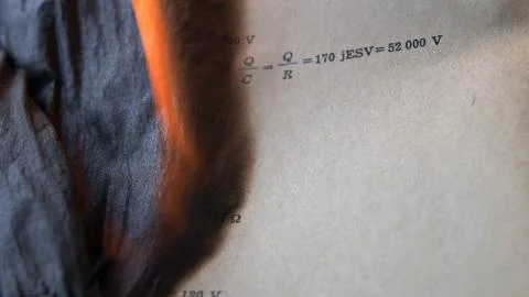 Burning Old Sheet of Paper with Mathematical Formulas and Equations Stock Photos