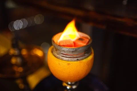 Burning orange hookah in cafe Stock Photos