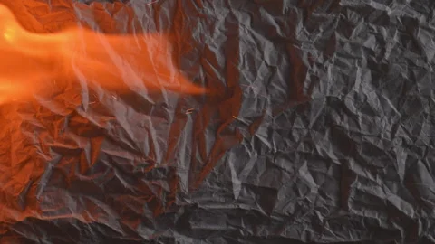 Burning paper with flame and glowing edges on dark background 库存影片 331943685