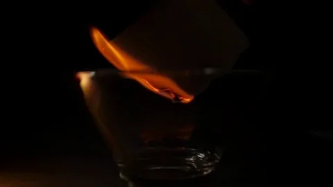 Burning paper in glass Stock Footage 69122945