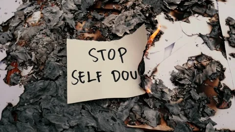 Burning paper with handwritten message STOP SELF DOUBT Stock Footage 255197266