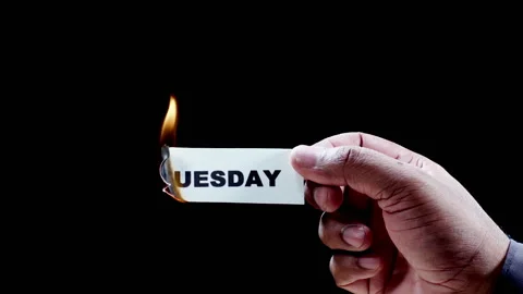 Burning Paper Writing Tuesday on it Stock Footage 248687485
