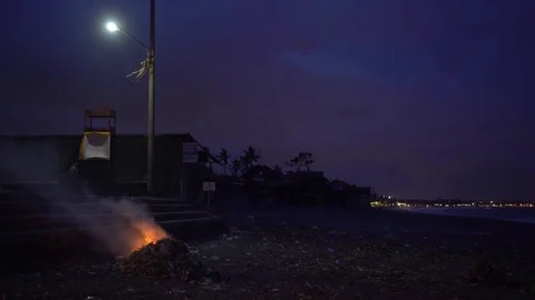 Burning pile of garbage on the beach at night Video stock 74295049