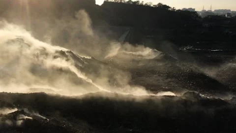 Burning pile of garbage at dump ground or landfill releasing toxic smoke Stock Footage 160846504