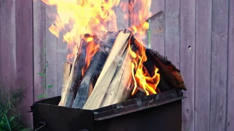 Burning pine logs for coals. Strong flame on the grill. Burning firewood on the Stock Footage 231185604