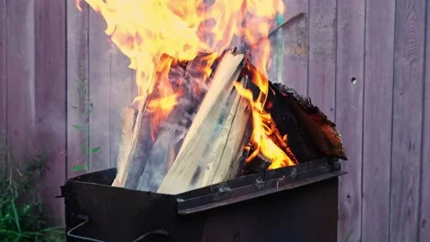 Burning pine logs for coals. Strong flame on the grill. Burning firewood on the Stock Footage 231518678
