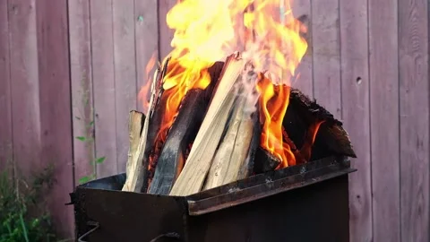 Burning pine logs for coals. Strong flame on the grill. Burning firewood on the Stock Footage 234166832