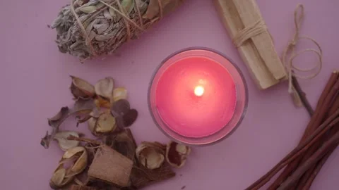 Burning pink candle with natural elements arranged on pink background overh.. Stock Footage 332058184