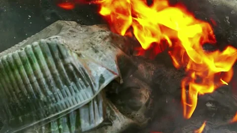 Burning plastic packaging pollutes the air with toxic smoke Stock Footage 227294625