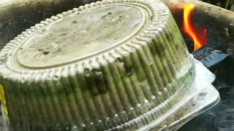 Burning plastic packaging pollutes the environment with toxic smoke Stock Footage 227299821