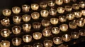 Burning Prayer Tea Candles Large Group Black Background Light Up Church Darkness HD Footage
