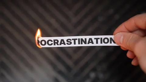 Burning “PROCRASTINATION” concept symbolizing action, discipline, focus Stock Footage 333653520
