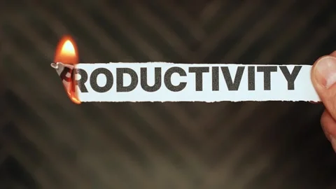 Burning “productivity” label held by hand, symbolizing procrastination Stock Footage 333655912