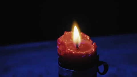 Burning Red Beeswax Candle With Flickering Flame In Dark Blue Light Stock Footage 329965269