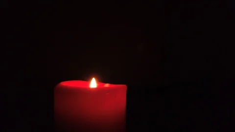 Burning red candle with flickering flame on dark background. Stock-Footage 105255167