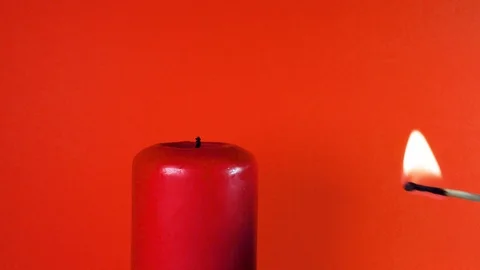 Burning Red Candle on a Red Background Video stock 113402806