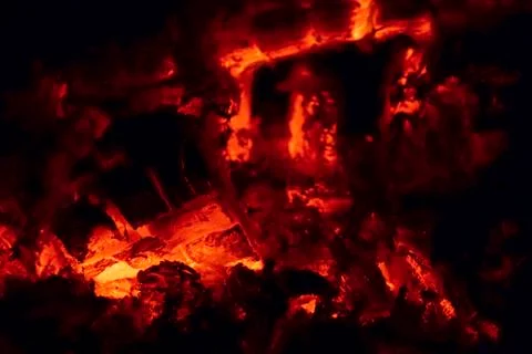 Burning red coals of a tree close up in a steam boiler Foto stock