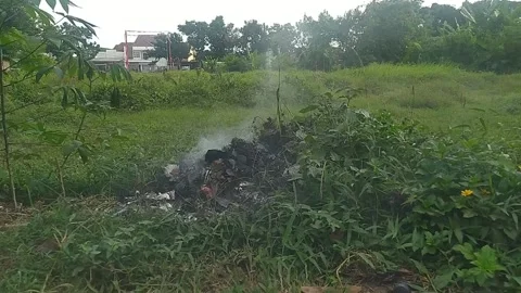 Burning rubbish in the garden Stock Footage 280106378