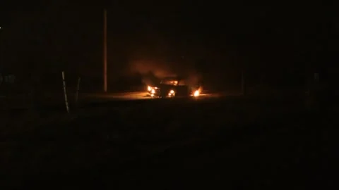 Burning Russian car in the night Stock Footage 273203820