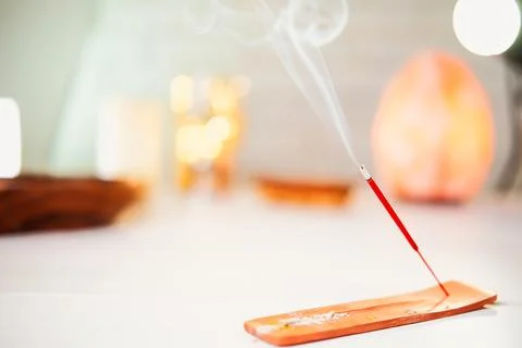 Burning scented stick burning on table Stock Photos