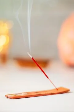 Burning scented stick burning on table Stock Photos