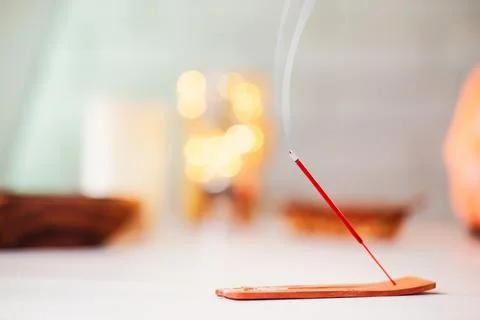 Burning scented stick burning on table Stock Photos