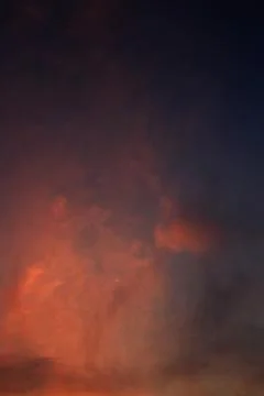 Burning sky, dramatic red colour clouds and sun ray shining through the heave Stock Photos