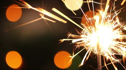 Burning sparkler on background blinking blurred garland Video stock 66348315