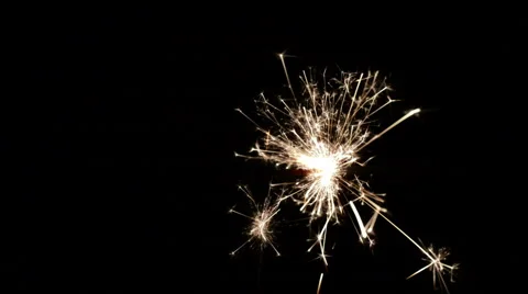 Burning sparkler on black background. Video stock 64345992