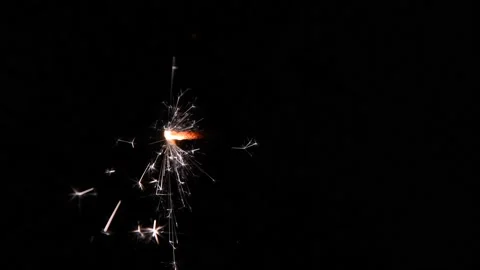 Burning sparkler on black background Stock Footage 168124048