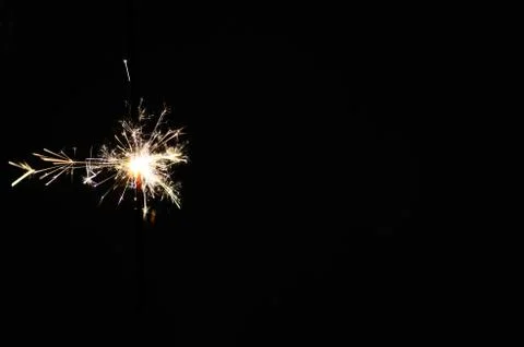 Burning sparkler on black background Stock Photos