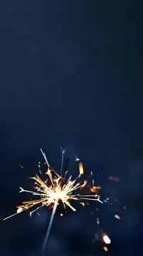 Burning sparkler on blue background, the concept of the holiday, vertical, 16 Stock Photos