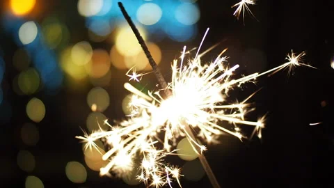 Burning sparkler with blurred Christmas lights in SLOW MOTION HD VIDEO. Stock Footage 134926041