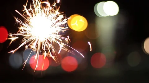 Burning Sparkler On Bokeh Light Background Vidéo 83008544