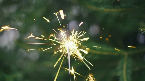 Burning sparkler close-up on the background of a Christmas tree Stock Footage 144278904