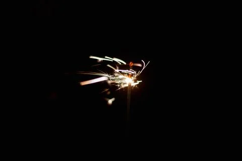 Burning sparkler on a dark background. 스톡 사진